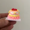 The finished cake held between fingers