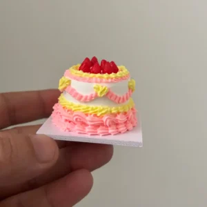 The finished cake held between fingers